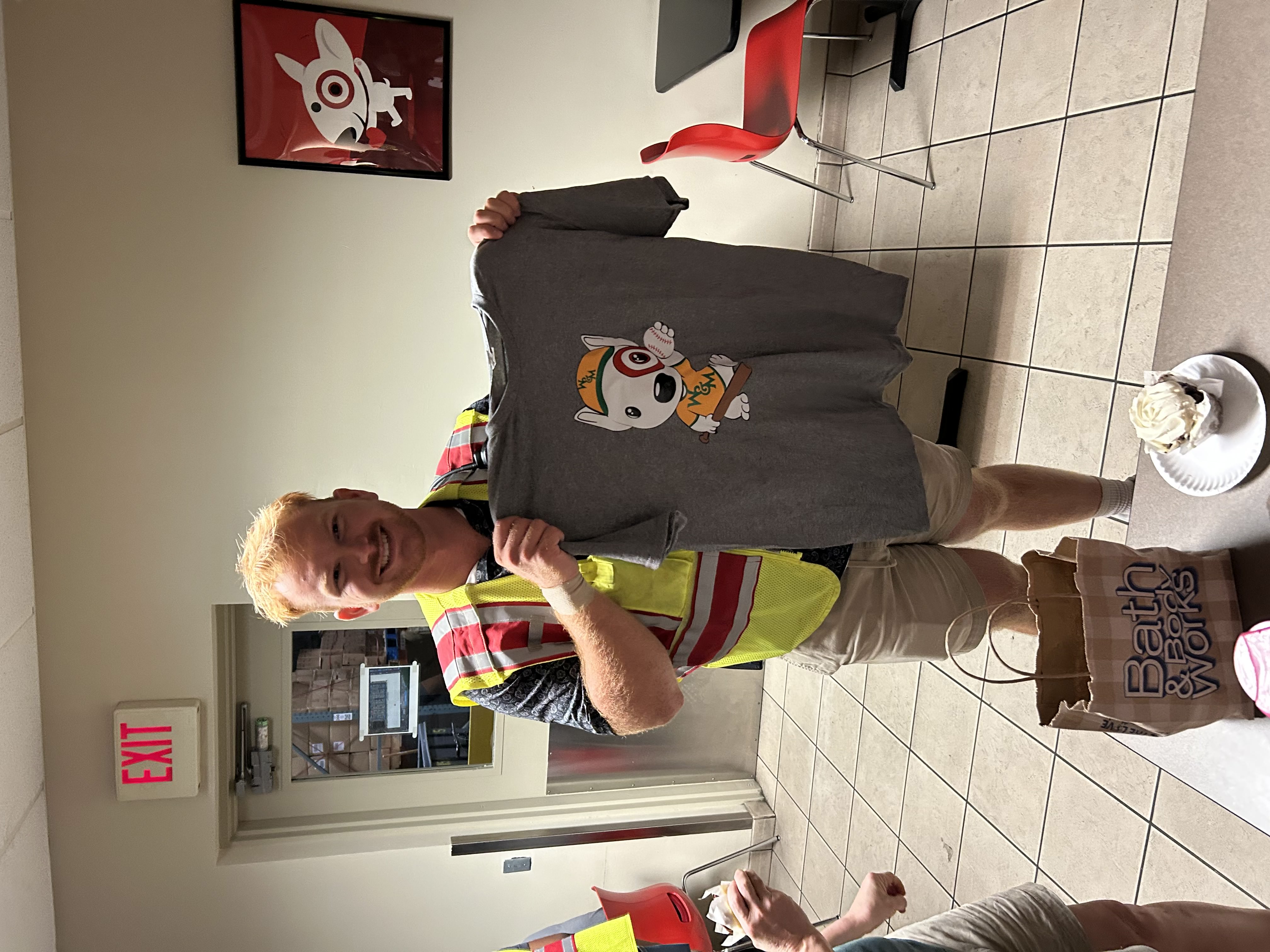 Witt's Target team presenting a custom W&M baseball shirt on his last day